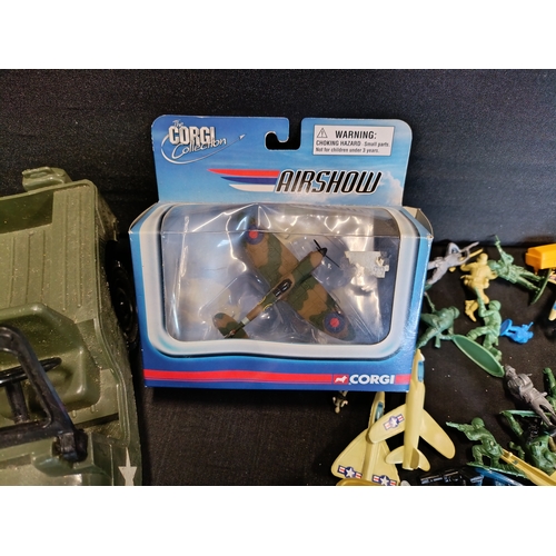 309 - Collection of military themed toys including a model Spitfire by Corgi