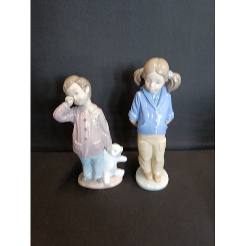 310 - 2 Nao by Lladro figurines, Girl with pigtails and satchel and Sleepy boy with teddy bear