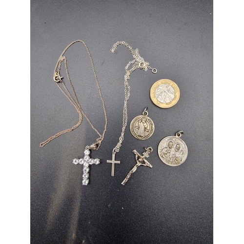 234 - A selection of sterling silver and silver religious items.  With two sterling silver chains.