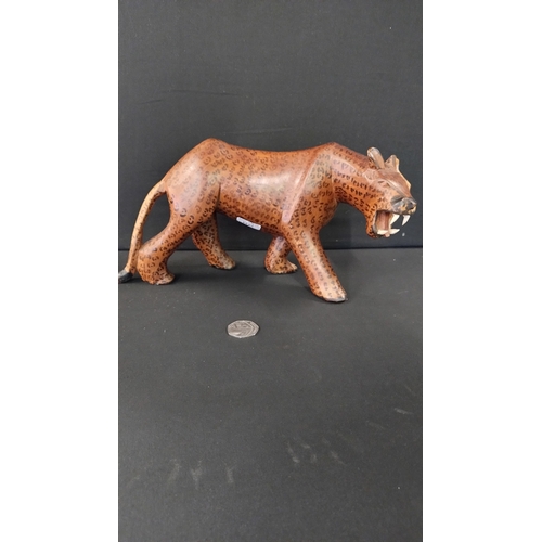 390 - Wooden leopard measures approximately H14.5 x L30 cm