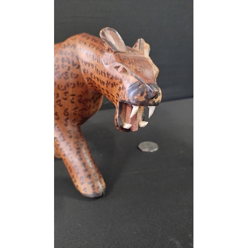 390 - Wooden leopard measures approximately H14.5 x L30 cm