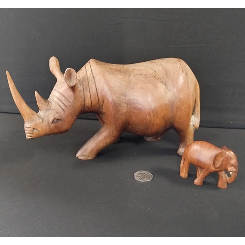 391 - Solid wooden rhino approximately 14 x 27 cm and small elephant 8 x 6 cm