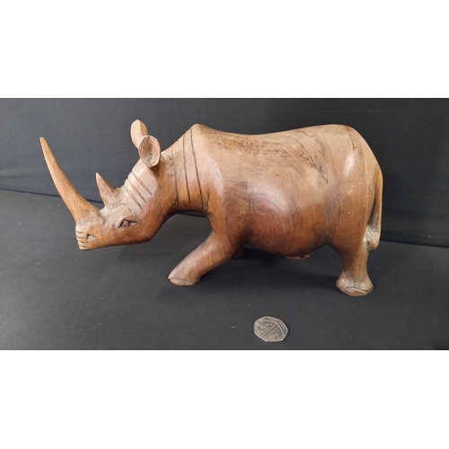 391 - Solid wooden rhino approximately 14 x 27 cm and small elephant 8 x 6 cm