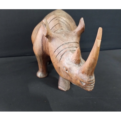 391 - Solid wooden rhino approximately 14 x 27 cm and small elephant 8 x 6 cm