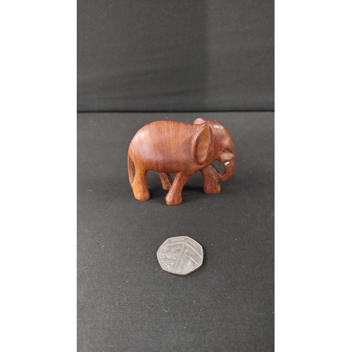 391 - Solid wooden rhino approximately 14 x 27 cm and small elephant 8 x 6 cm