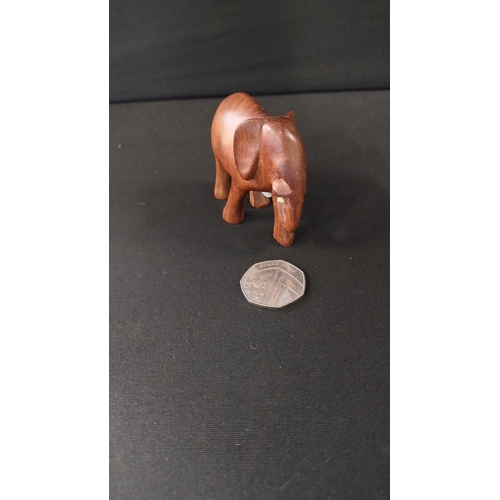 391 - Solid wooden rhino approximately 14 x 27 cm and small elephant 8 x 6 cm