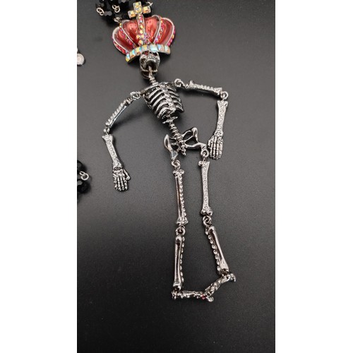 11 - Butler and Wilson Crystal Hanging Skeleton Necklace approximately 37 cm /14 in length, red enamel an... 