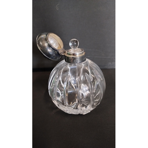 101 - Perfume bottle with a sterling silver hallmarked top and stopper, measures approx H 5 x W 4 in