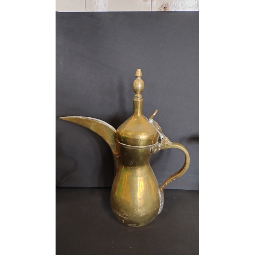 103 - 3 Arabic brass teapots and a vintage carpet beater