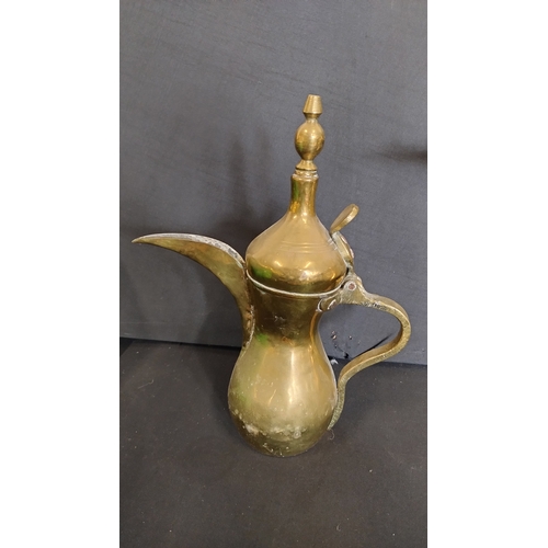 103 - 3 Arabic brass teapots and a vintage carpet beater