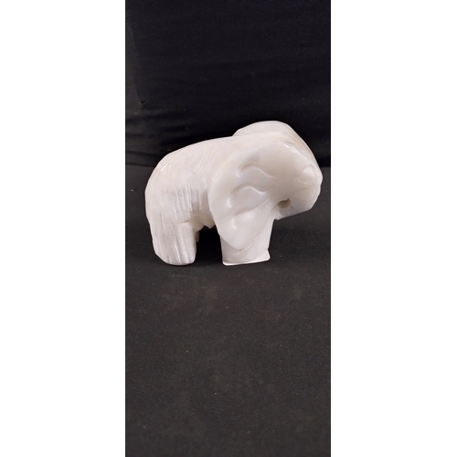 35 - White marbled alabaster elephant. Measures approx H 6.5 x W 9.5 x D 3.5 cm