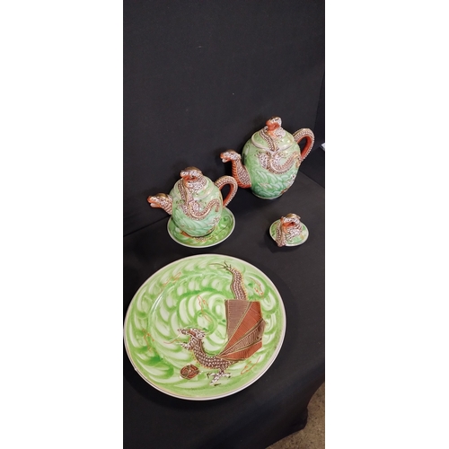 69 - Naritaki tea pots, side plates, cups and saucers and a plate