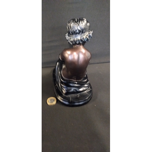 83 - Bronze and black Resin Figure of a child seated with a book. Measures approx H 17.5 x W 18.5 x D 11 ... 