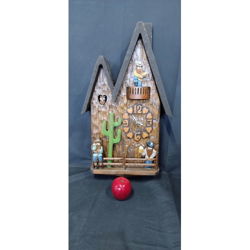 27 - A unique battery operated cuckoo clock with cowboys and an owl. Measures approx H 65.5 x W 35.5 x D ... 