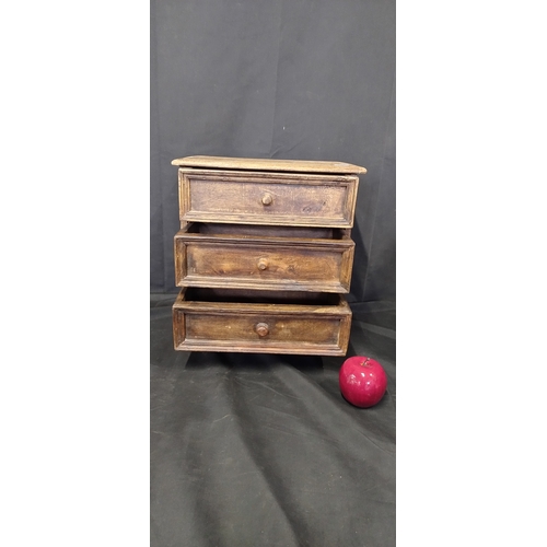 28 - Small distressed solid wooden 3 drawer unit. Measures approx H 35 x W 33.5 x D 20 cm