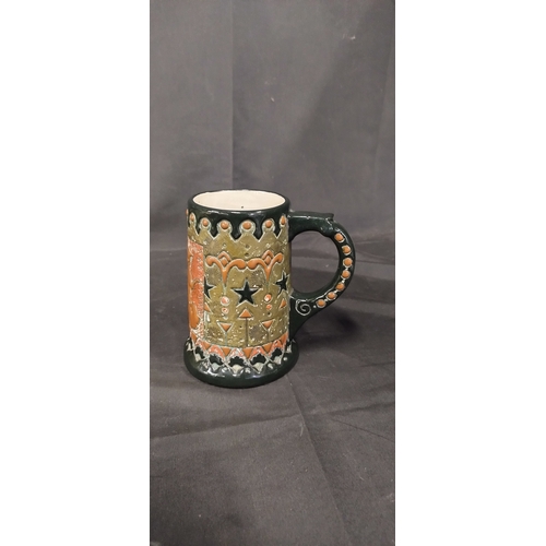 36 - Four beer steins with various designs