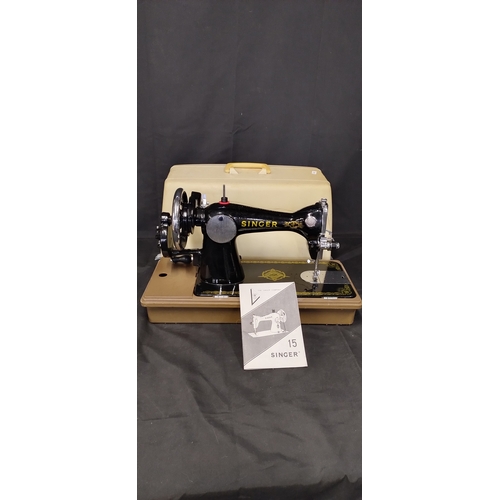 49 - Vintage portable Singer sewing machine with lid and instruction booklet