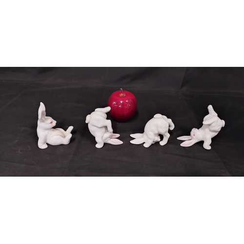 51 - Four white porcelain rabbits in various poses