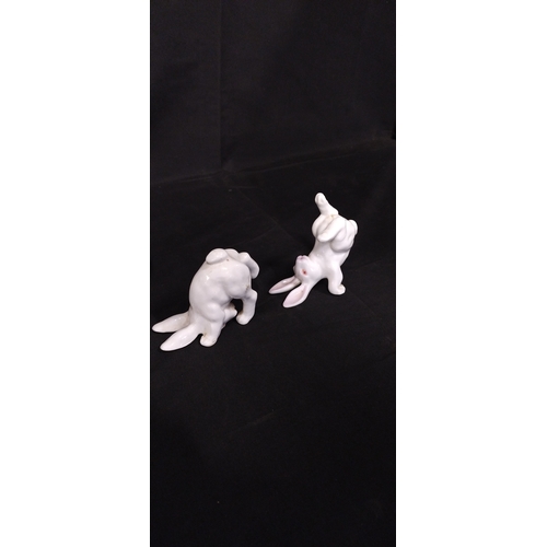 51 - Four white porcelain rabbits in various poses