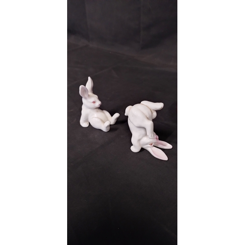 51 - Four white porcelain rabbits in various poses