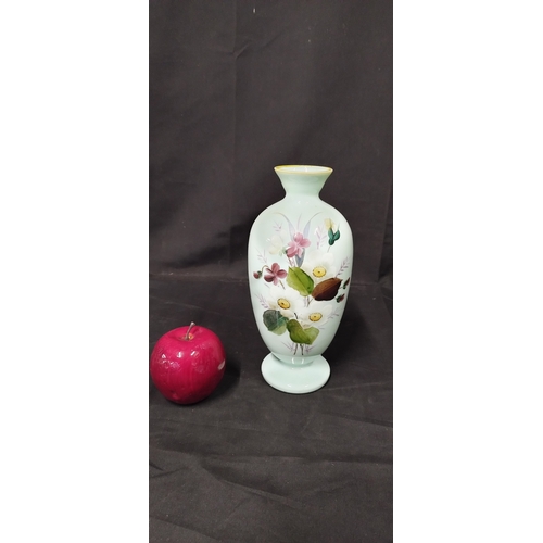 62 - Pale green uranium glass vase with a floral design .Measures approx H 24 x W 9 .5 cm