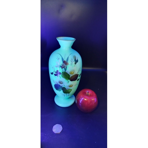 62 - Pale green uranium glass vase with a floral design .Measures approx H 24 x W 9 .5 cm