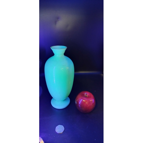 62 - Pale green uranium glass vase with a floral design .Measures approx H 24 x W 9 .5 cm