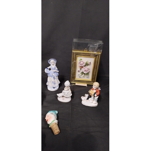 64 - Mixed lot of ornaments including a figurine of an Inuit Eskimo mother and child, porcelain flowers o... 