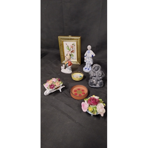 64 - Mixed lot of ornaments including a figurine of an Inuit Eskimo mother and child, porcelain flowers o... 