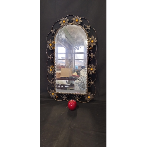 88 - Vintage metal framed mirror with flower decoration. Measures approx H 74.5 x W 44.5 cm