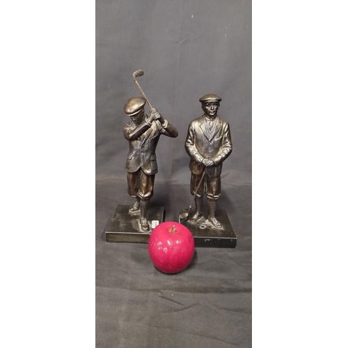 99 - Two golfing figurines measures approx H 27.5 x W 10 cm