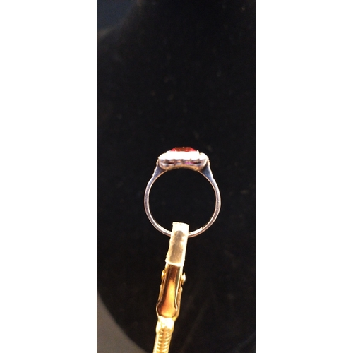 4 - 9ct white gold ring set with a red stone size M. Weight approx 3.11g