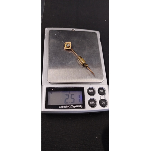 11 - 9ct gold tie/lapel pin with a turquoise stone set in the centre. Weight approx 2.51g