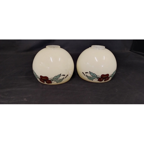 191 - Two opaque glass pendant lampshades with a floral trim.