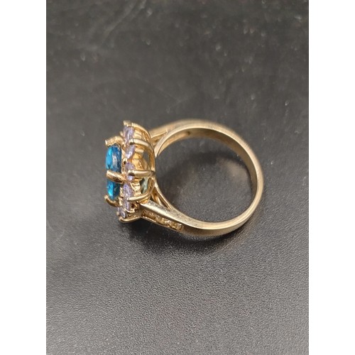 147 - 9ct gold ring with Swiss blue topaz stone and surrounded by tanzanite with yellow Beryl on the shoul... 