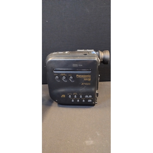 221 - Panasonic VHS-C Movie camera. NV S100. Battery charger, battery, lens and camera bag