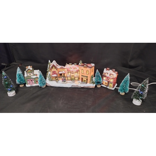 227 - Electric Illuminated village scene with model trees,  and battery operated trees, toy shop wax burne... 