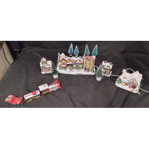 227 - Electric Illuminated village scene with model trees,  and battery operated trees, toy shop wax burne... 