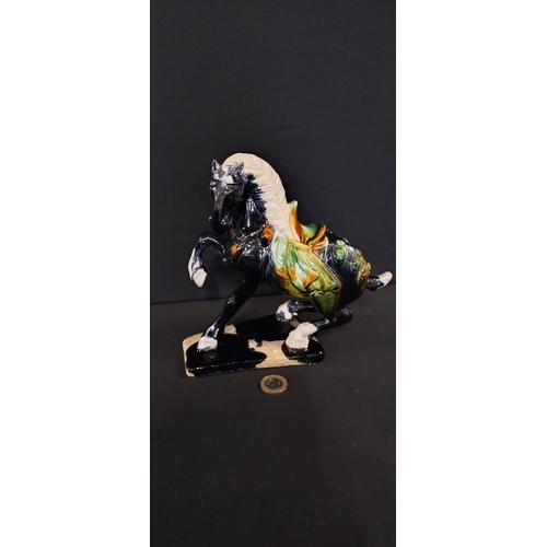 266 - Figurine of a tang horse with drip glaze. Measures approx H 19 x W 20 x D 9 cm