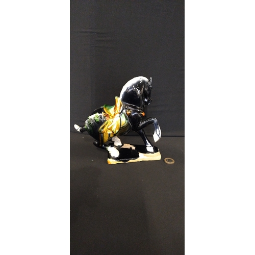 266 - Figurine of a tang horse with drip glaze. Measures approx H 19 x W 20 x D 9 cm