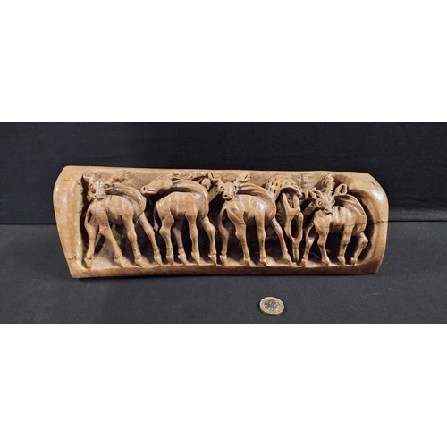 275 - heavy wooden hand carving of deer. Measures approx H 11 x W 34.5 x D 7 cm