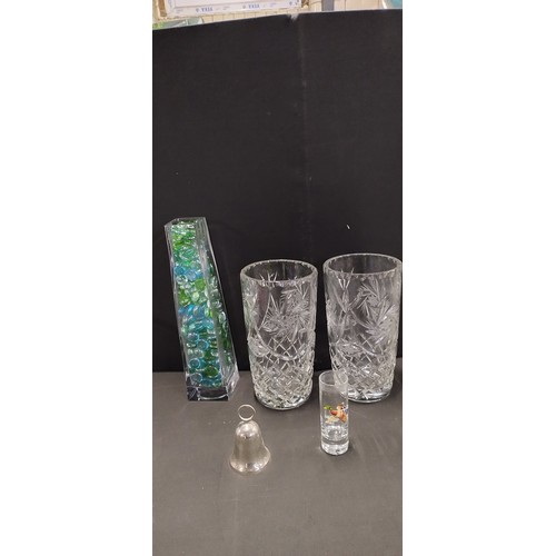 284 - Collection of pin wheel crystal vases, barrel vases, silver plated flower posy vase and other items