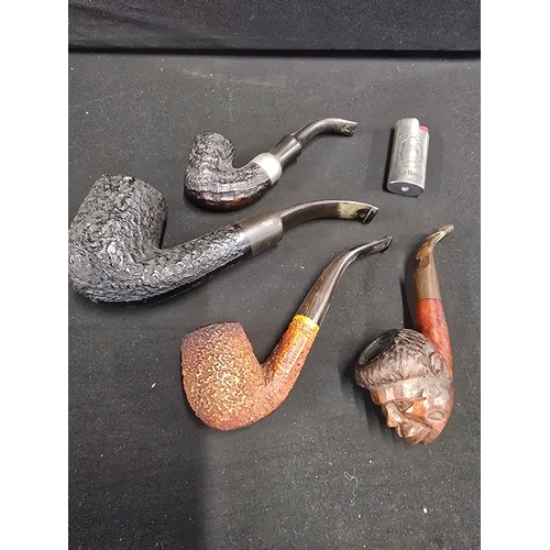 481 - Four vinatge pipes and a lighter.  One with engraved aboriginal face