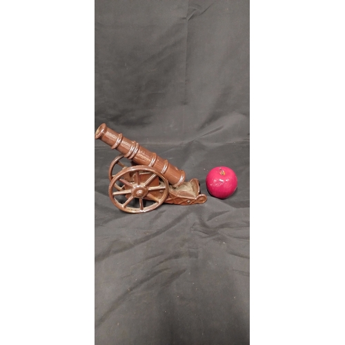 34 - Heavy Cast Iron cannon With a brown Lustre Finish with place for pokers to rest inside. Measures app... 