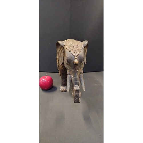 92 - Large resin statue of a decorated Indian elephant. Measures approx H 27 x W 44 x D 14 cm