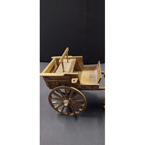 115 - Solid brass horse and cart. Measures approx H 21.5 x W 38 x D 14 cm