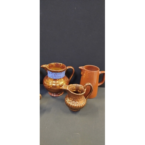 219 - Selection of copper luster ware blue stripe jugs and a brown stoneware jug