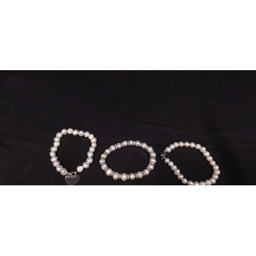 37 - Five pearl bracelets, pearl bracelet watch and a pearl necklace