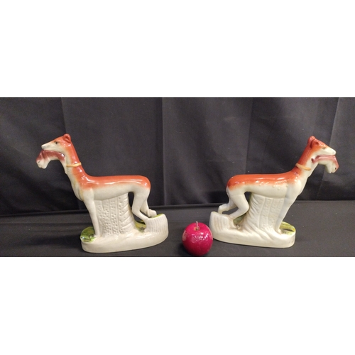 161 - Pair of whippets with rabbits. Possibly Staffordshire pottery