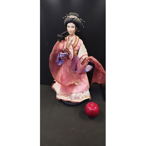 187 - Two oriental collectors dolls on stands